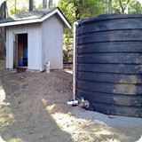 

Tank and pump house: The well fills the holding tank automatically. A booster pump system carries the water to the house.