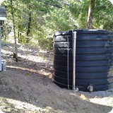 Tank and pump house: The well fills the holding tank automatically. A booster pump system carries the water to the house.